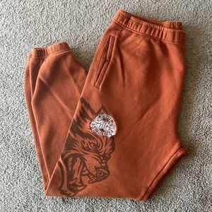 Darc Sport Orange Sweatpants with Wolf Graphic